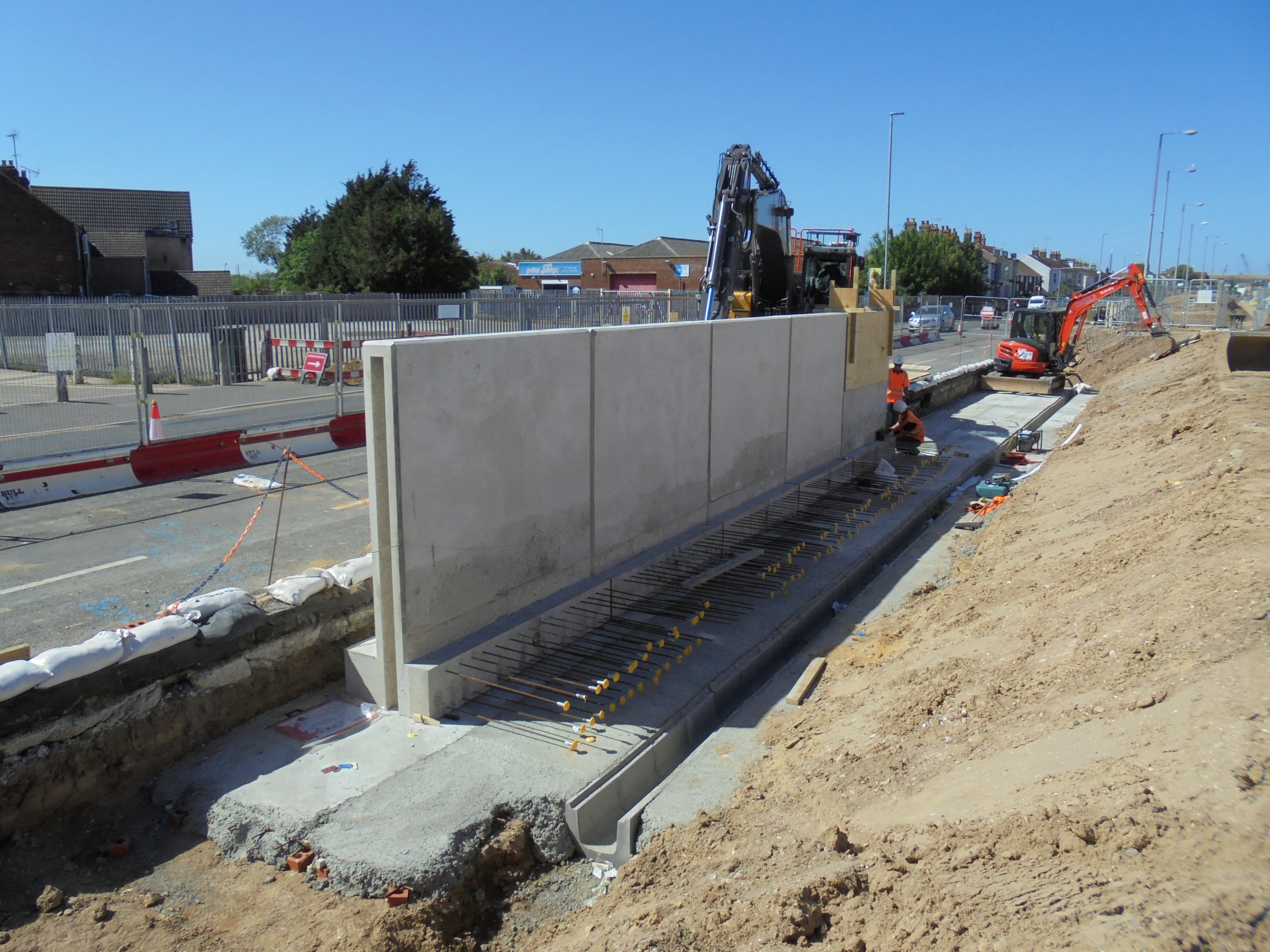 Construction of the new re-enforced concrete flood wall at Bollards Quay, Southown Road (WP03)